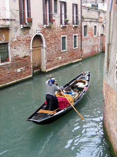 Image of a gondola in a canal in Venice.